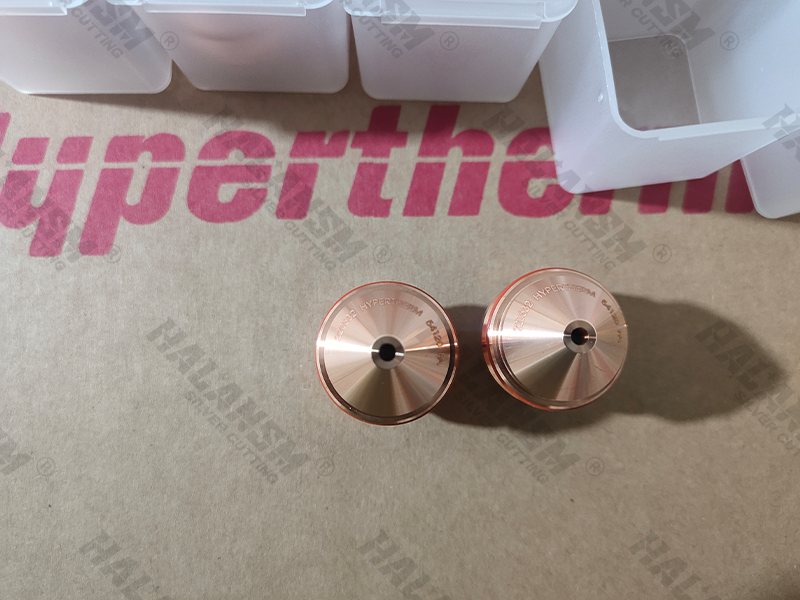 Top-down macro view of two HALANSM 220632 bevel nozzles showcasing precision lathe finishing and OEM part number engraving.